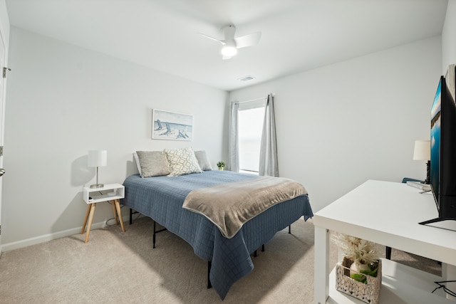 bedroom featuring ceiling fan, light colored carpet, visible vents, and baseboards