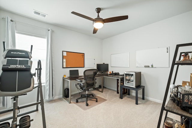 office area with light carpet, visible vents, baseboards, and a ceiling fan