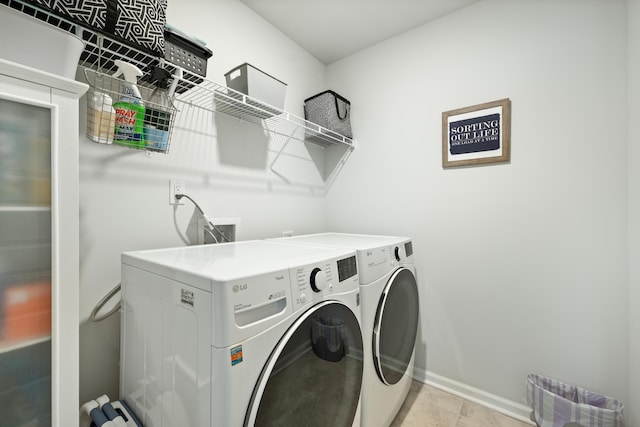 laundry area featuring baseboards, laundry area, and washer and clothes dryer