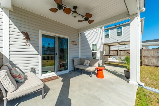 view of patio / terrace featuring outdoor lounge area, fence, and ceiling fan