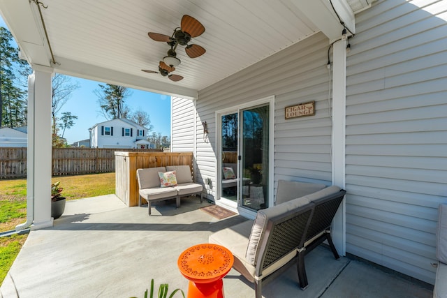 view of patio / terrace with ceiling fan and fence