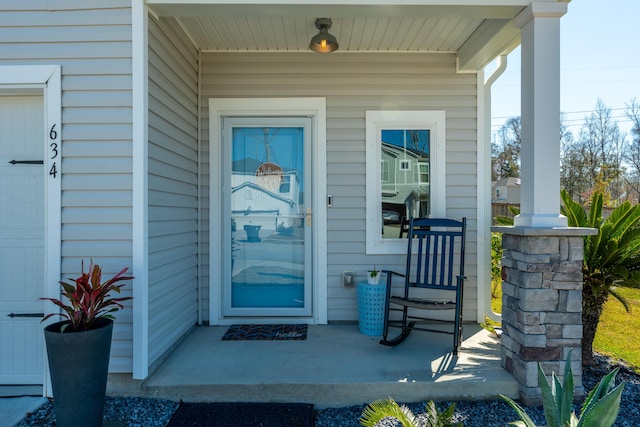 view of exterior entry with a porch