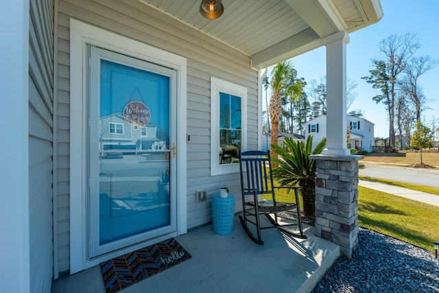 view of exterior entry featuring a porch