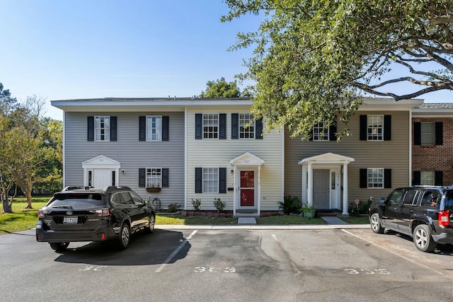 view of property with uncovered parking