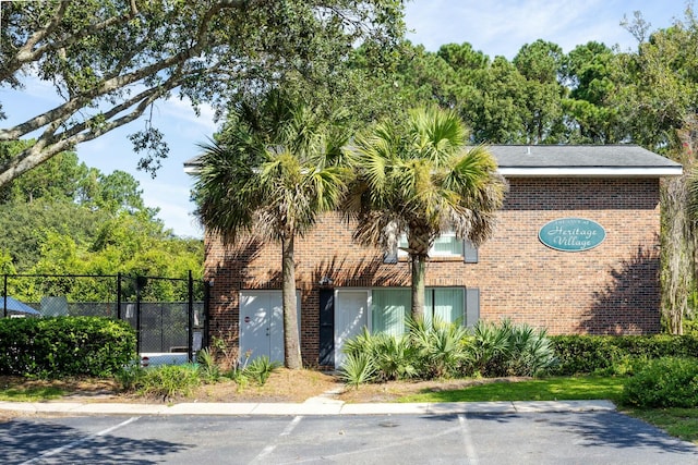 view of building exterior with fence