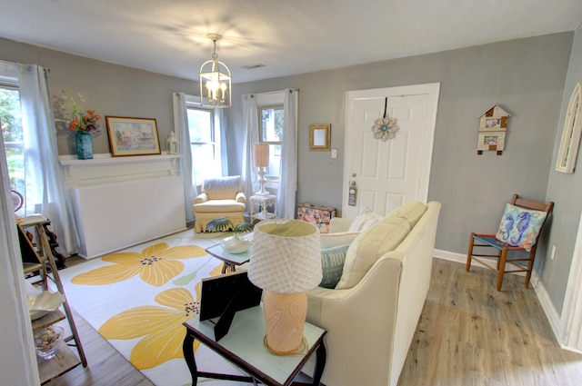 dining area with an inviting chandelier and light hardwood / wood-style flooring