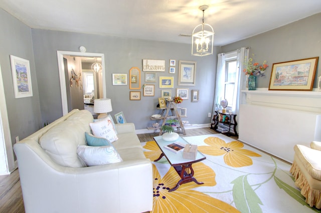 living room with an inviting chandelier and hardwood / wood-style floors