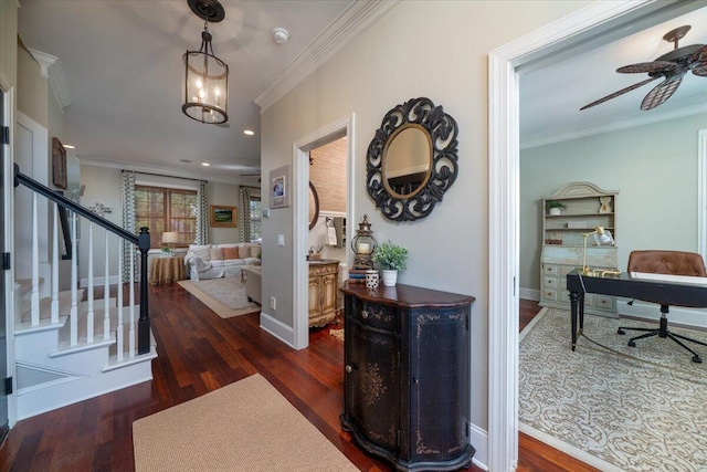 foyer with ornamental molding, wood finished floors, and baseboards