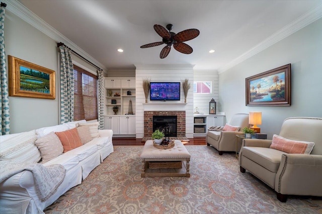 living room featuring ceiling fan, recessed lighting, a fireplace, wood finished floors, and ornamental molding