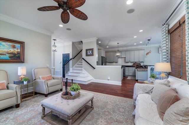 living room featuring crown molding, recessed lighting, stairway, a ceiling fan, and wood finished floors