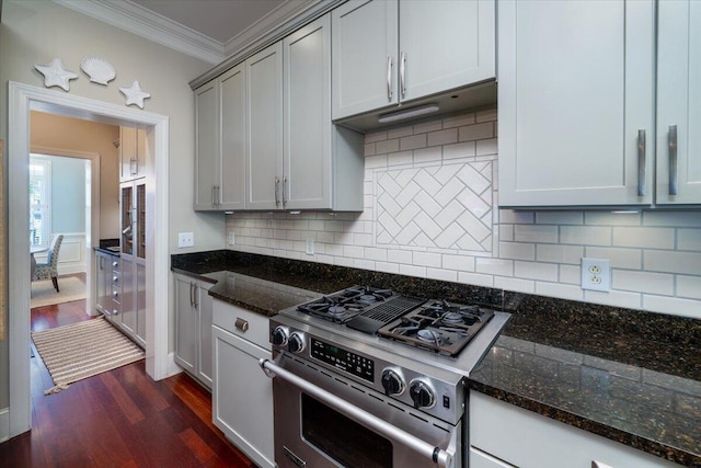 kitchen featuring ornamental molding, high end range, dark stone countertops, and dark wood-style floors