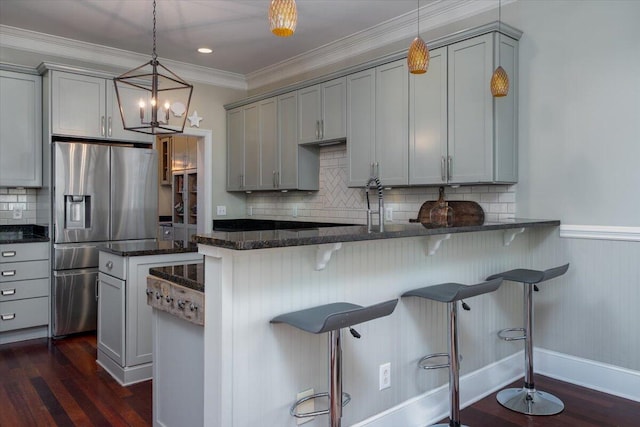 kitchen with ornamental molding, dark wood-style flooring, gray cabinets, and stainless steel fridge with ice dispenser