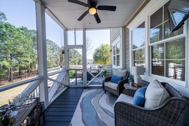 sunroom with a ceiling fan