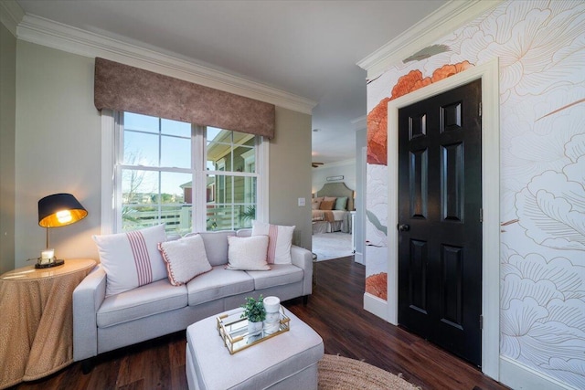 living area with baseboards, wood finished floors, and crown molding