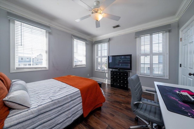 bedroom with visible vents, crown molding, multiple windows, and wood finished floors