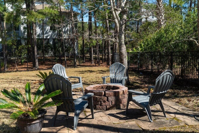 view of patio featuring an outdoor fire pit and fence