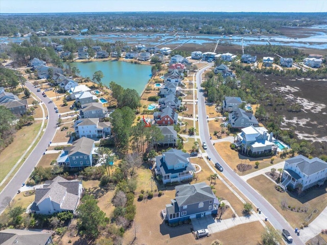 birds eye view of property with a water view and a residential view