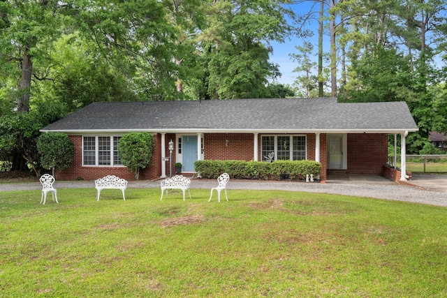 ranch-style home featuring a front yard, brick siding, and a shingled roof