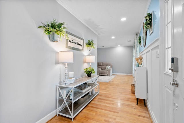 entrance foyer with ornamental molding, light wood finished floors, baseboards, and recessed lighting