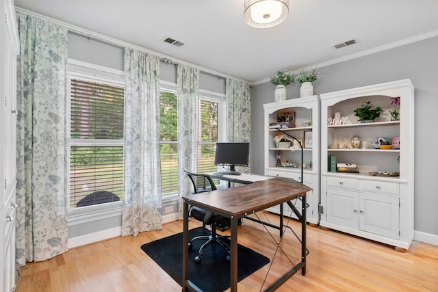 office with ornamental molding, light wood-style flooring, and baseboards