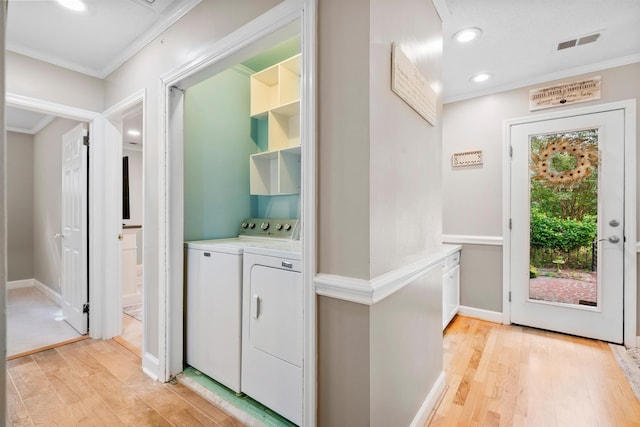 laundry area with washer and clothes dryer, ornamental molding, light wood finished floors, recessed lighting, and baseboards