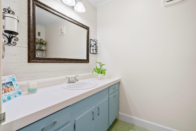 bathroom featuring vanity, baseboards, crown molding, and tile patterned flooring