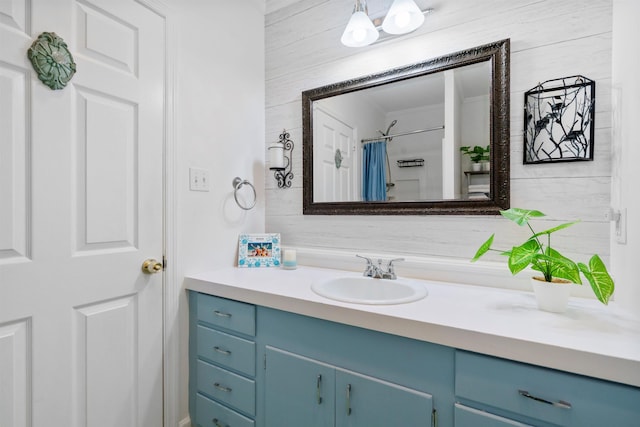 full bathroom with vanity, a shower with shower curtain, and ornamental molding