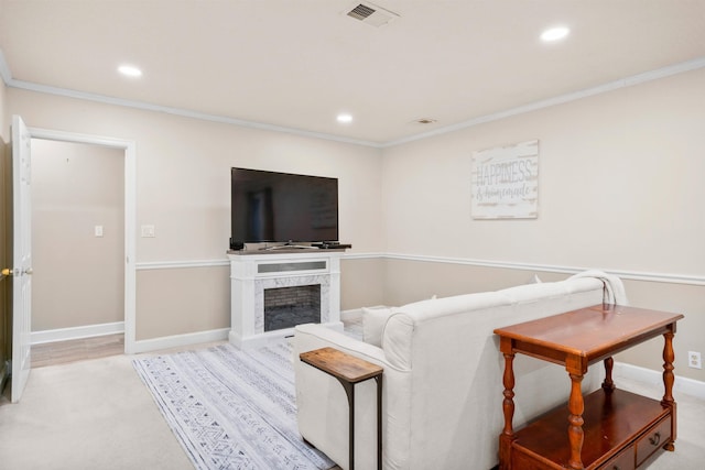living room featuring crown molding, recessed lighting, baseboards, a fireplace, and light colored carpet