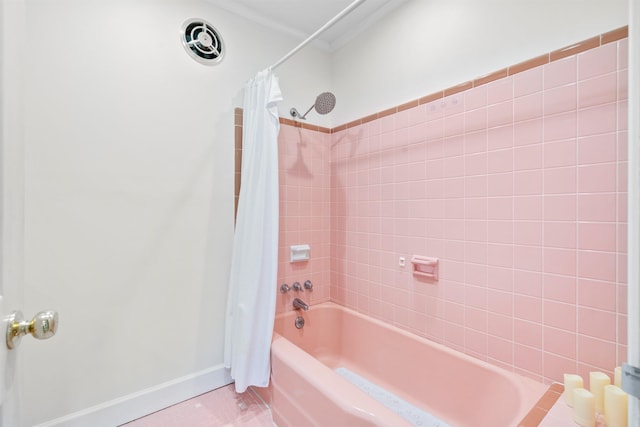 full bathroom featuring shower / bath combo, crown molding, and baseboards