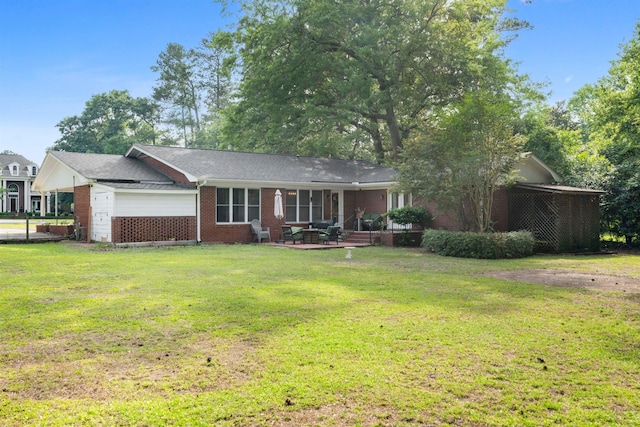 ranch-style home featuring brick siding, a front lawn, and a garage