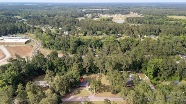 aerial view of property and surrounding area featuring a forest