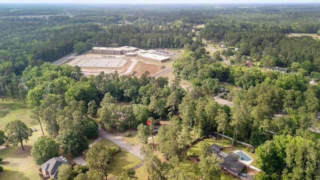 view of property location with a heavily wooded area