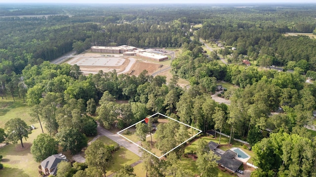 view of property location with a heavily wooded area and property boundaries highlighted