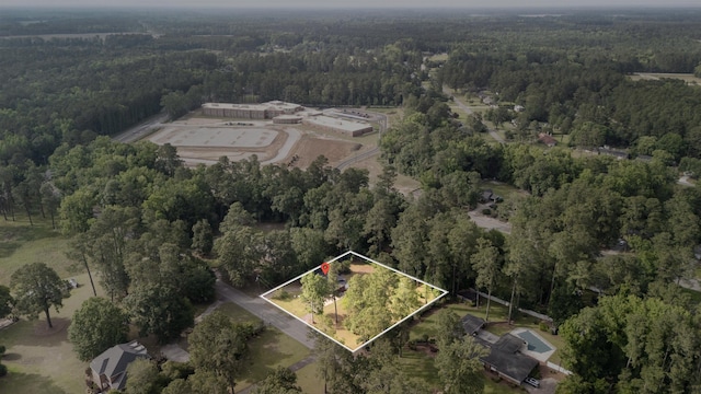 aerial overview of property's location featuring a heavily wooded area and property boundaries highlighted