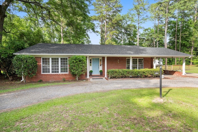 single story home with a front lawn, brick siding, and driveway