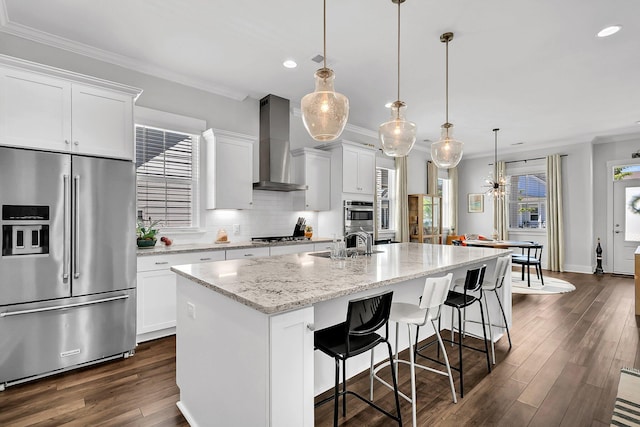 3529 Habenaria Rd Unit 33, Mount Pleasant, SC 29466 - kitchen featuring stainless steel appliances, wall chimney exhaust hood, recessed lighting, ornamental molding, and a kitchen island with sink