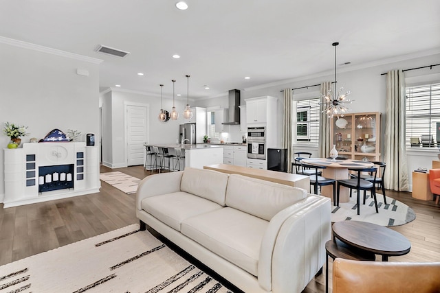 3529 Habenaria Rd Unit 33, Mount Pleasant, SC 29466 - living room featuring ornamental molding, wood finished floors, recessed lighting, baseboards, and a chandelier