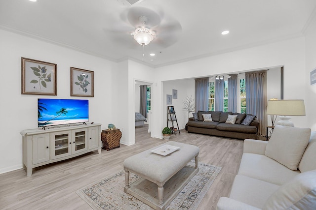 living area featuring crown molding, baseboards, ceiling fan, light wood-type flooring, and recessed lighting