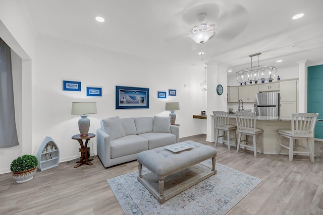 living room with recessed lighting, light wood-type flooring, and baseboards