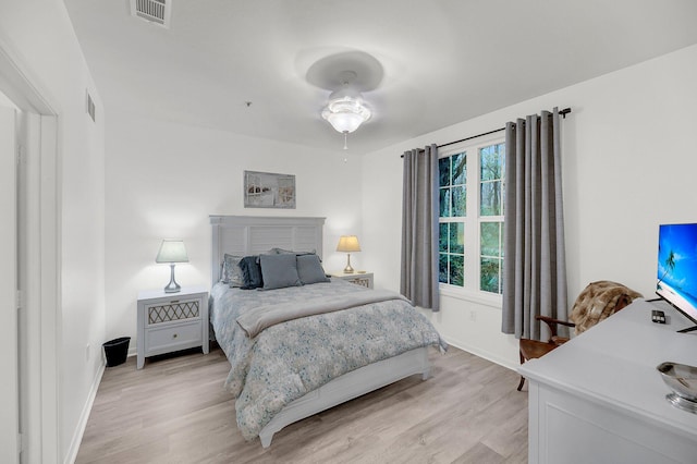 bedroom featuring light wood-style flooring, baseboards, and visible vents