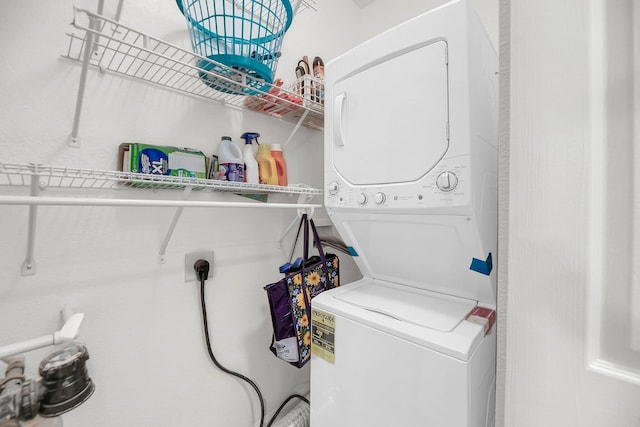 laundry room featuring laundry area and stacked washer and clothes dryer