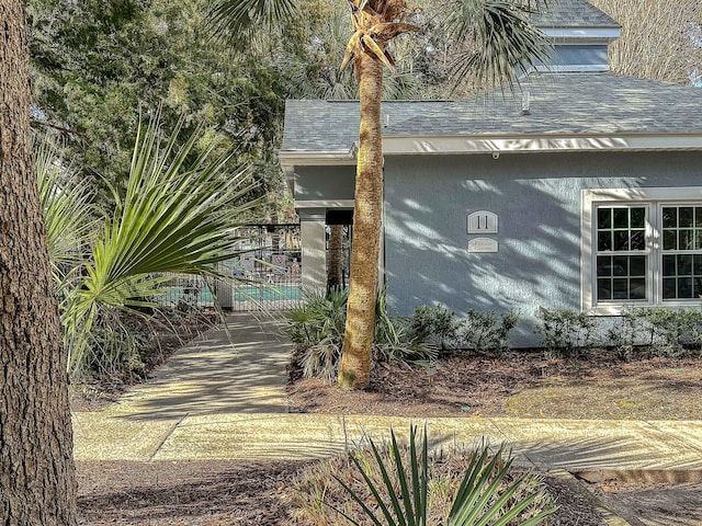 view of side of property featuring a shingled roof