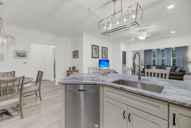 kitchen featuring light stone countertops, a sink, dishwasher, crown molding, and decorative light fixtures