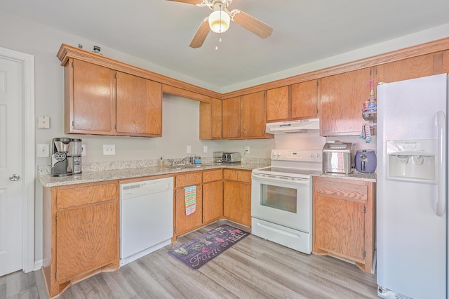 kitchen with white appliances, a ceiling fan, light wood-style flooring, a sink, and under cabinet range hood