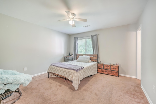 carpeted bedroom featuring visible vents, baseboards, and a ceiling fan