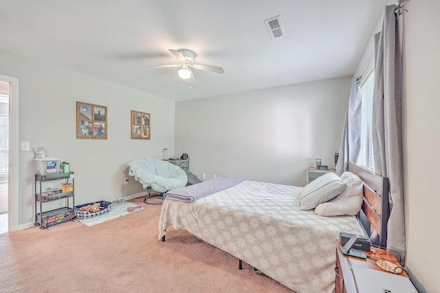 carpeted bedroom featuring visible vents and ceiling fan