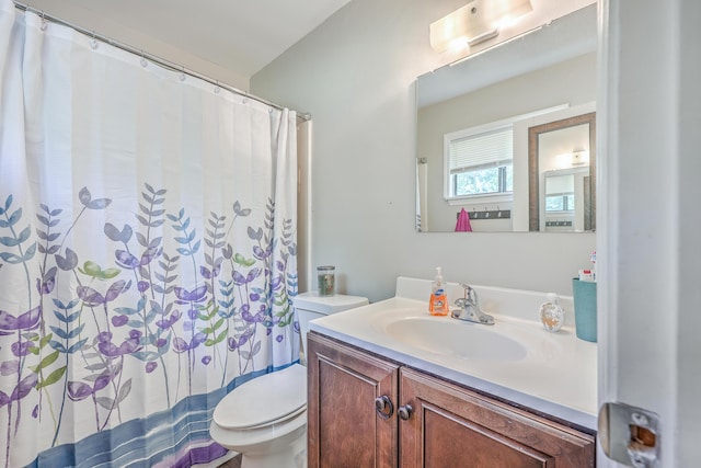 bathroom with toilet, vanity, and a shower with curtain