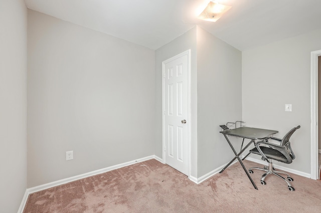 carpeted office featuring baseboards