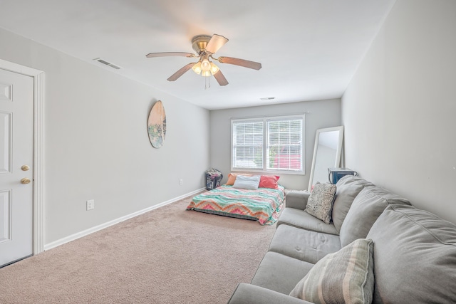 carpeted bedroom featuring visible vents, baseboards, and ceiling fan