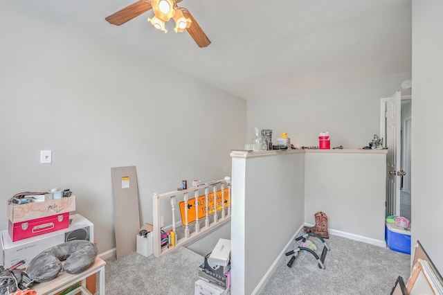 rec room with baseboards, a ceiling fan, and carpet flooring